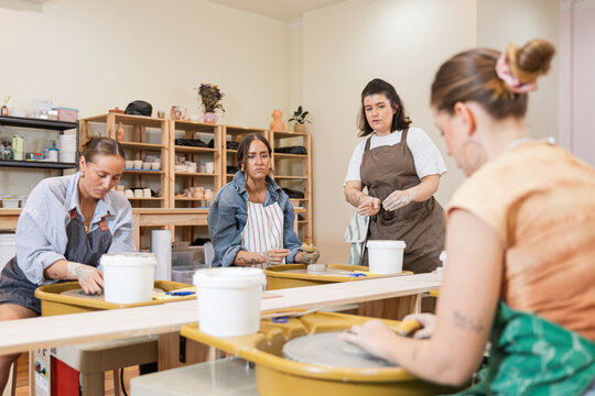 Group of women collaborating in a pottery class