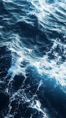 Fototapeta premium Turbulent ocean waves with white foam and blue water texture
