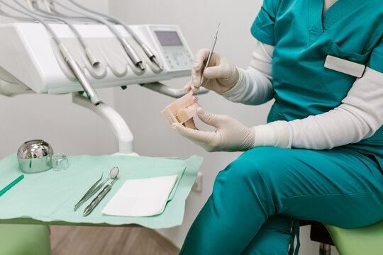 Dental Professional Demonstrating Technique in a Clinical Setting