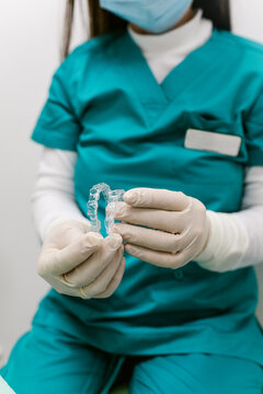 Dentist Holding Aligners POV