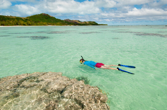 Woman snorkelling, Aitutaki Island, The Cook Islands.