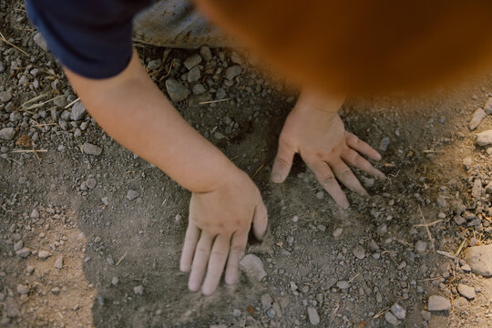 Child playing with dirt outdoors