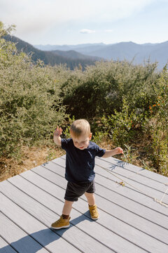 Toddler walking on mountain deck