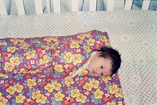  Newborn Baby Swaddled in Floral Blanket
