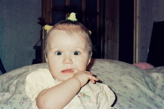 Baby with Pigtails and Finger in Mouth