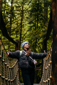 Woman hiking in green winter forest