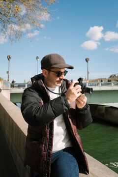 Tourist Taking Photo by Seine