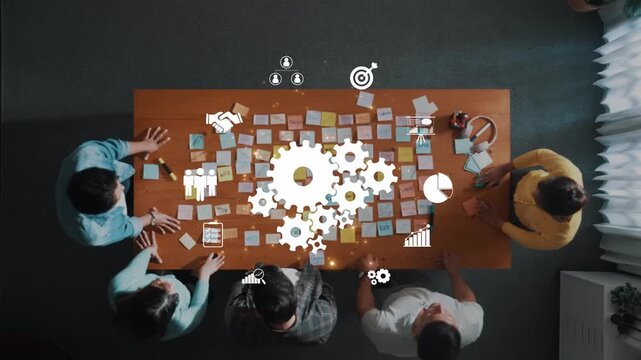 A dynamic team collaborates at a table surrounded by sticky notes and gear symbols, representing brainstorming, strategy formulation, and innovative planning for business success. Raster