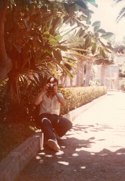 Vintage Photographer in Tropical Garden
