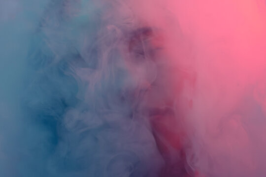 Blurred woman face by surreal smoke texture