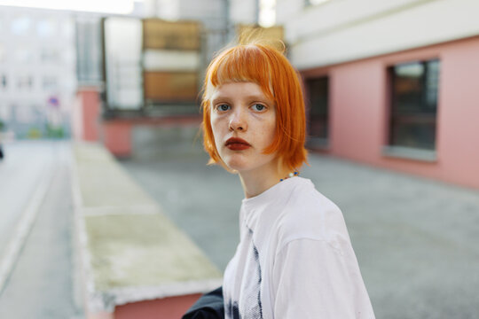 Young Woman with Red Hair Outdoors in an Urban Setting