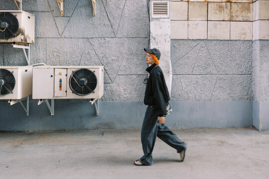 Urban Scene with Person Walking by a Wall with Air Conditioners