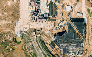new building under construction. aerial view of construction site with a crane and construction materials.
