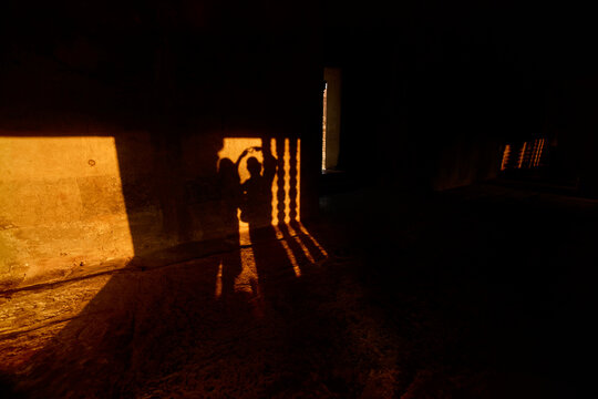 Couple playing Shadows Cast by Window at Angkor Temple