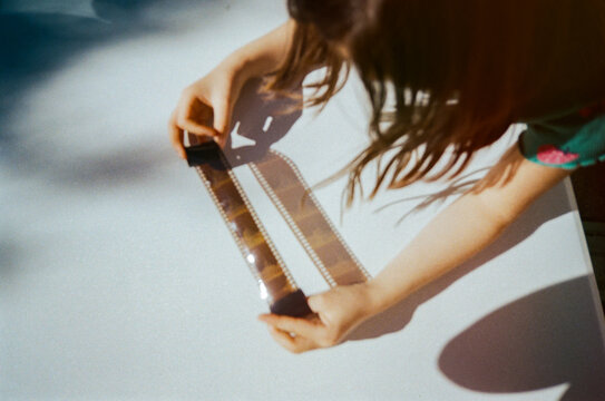 Child Examining Film Strip