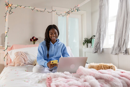 Teen texting at Home bedroom 