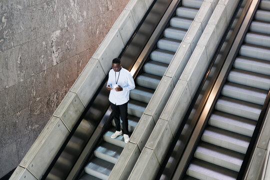 Man with Coffee on Escalator Ride