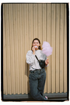 Film portrait of woman eating cotton candy