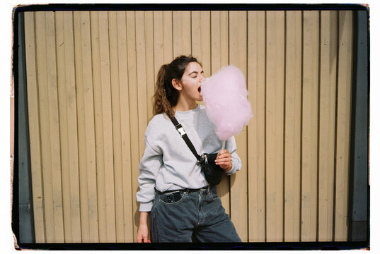 Film portrait of woman eating cotton candy