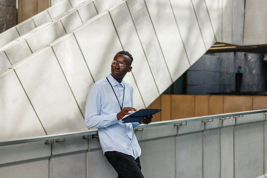 Professional man using tablet in office atrium