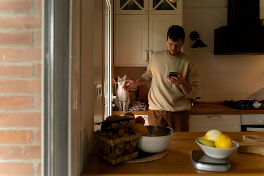 Man cooking with cat 