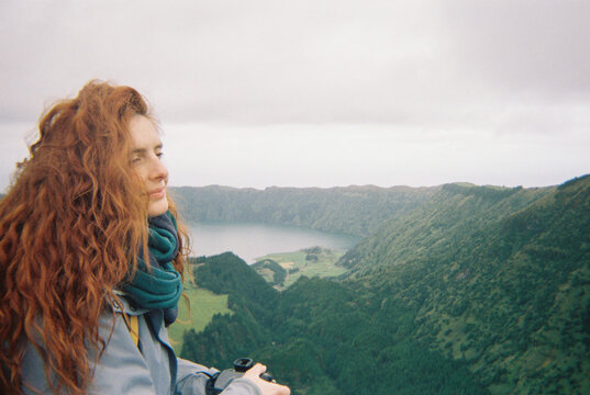 Woman overlooking green valley