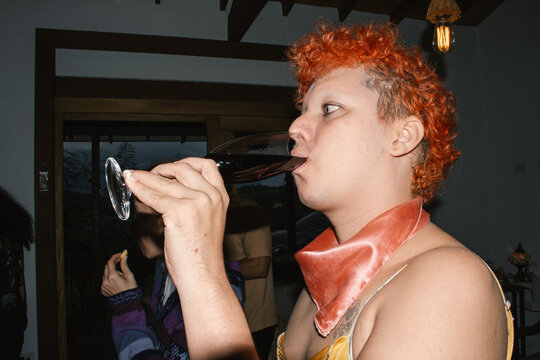 Person drinking wine indoors