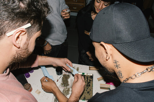 group of friends rolling joints 