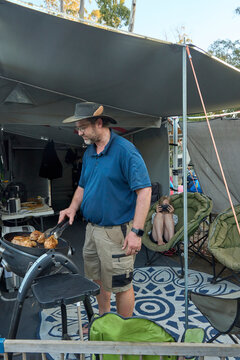 Dad cooking on outdoor barbecue at campsite