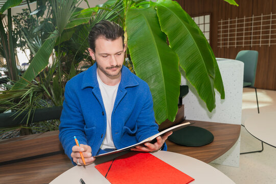 Man Reviewing Notes In Lounge