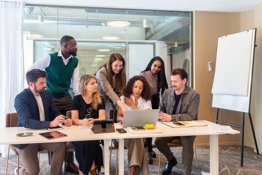 Business Team Collaborating On Laptop