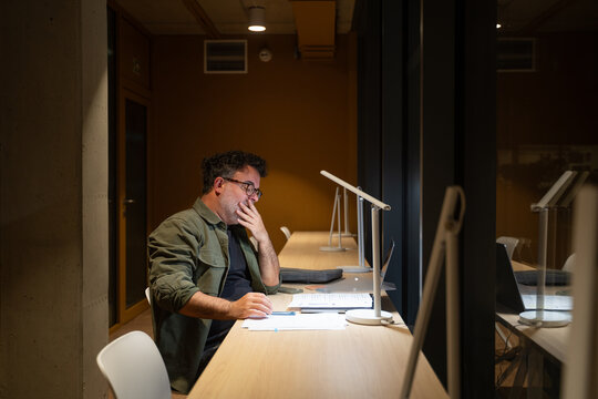 Businessman Yawning While Working At Late Night