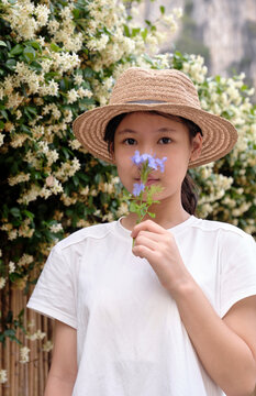 Chinese girl under the jasmine wall of wind chimes