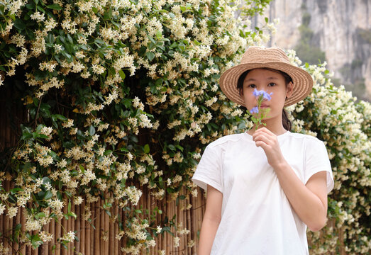 Chinese girl under the jasmine wall of wind chimes