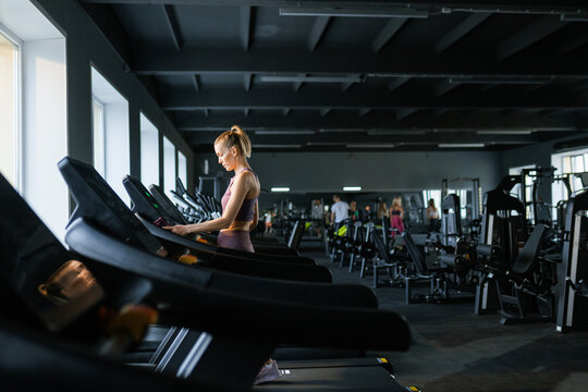 A woman on a treadmill in the gym