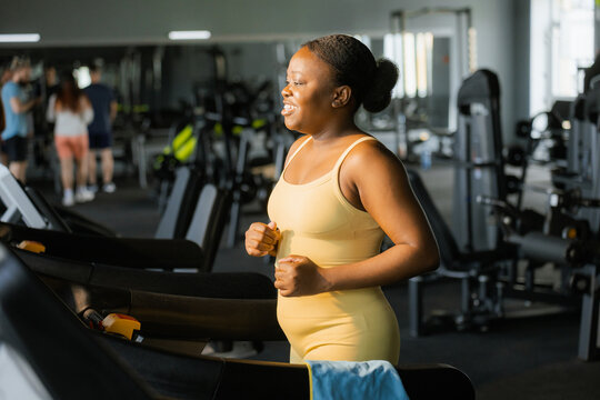 A woman on a treadmill in the gym