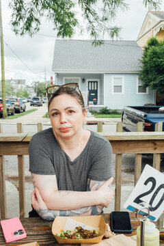 Woman Sitting at Outdoor Restaurant