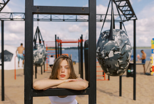 Young Woman Engaging in Outdoor Fitness Training on a Sunny Beach Day