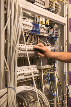 Anonymous man's hand adjusting a smart home system during repairs.