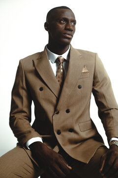 Portrait of a male model wearing a brown business suit