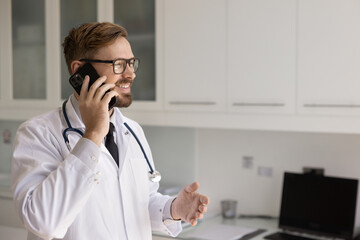 Remote consultation from doctor. Confident smiling young male physician therapist gp holding phone...