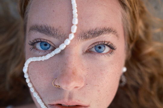 Redheaded Girl with Pearls on Face