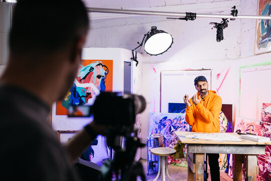 Artist explaining while being filmed

