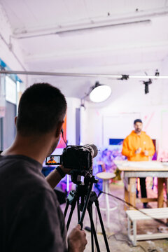 Camera screen focused on speaking artist


