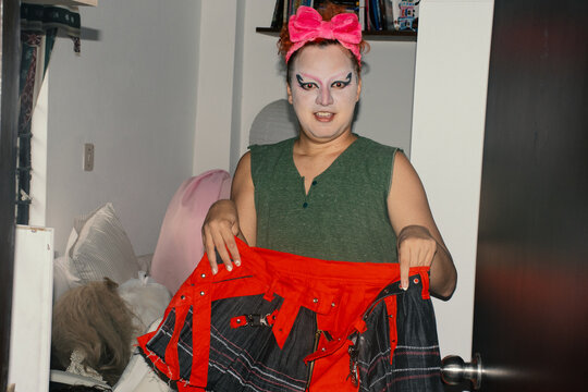 Drag performer trying on skirt 