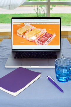 Laptop with frozen soup selection on screen on table during daytime