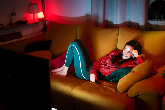 Relaxed woman watching funny tv stream