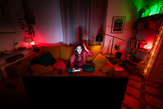 Cheerful gamer having fun playing at home