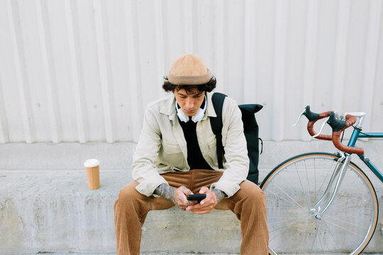 Man on phone beside vintage bike