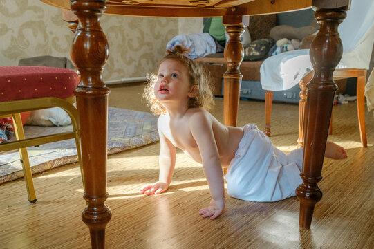 
baby crawling under the table